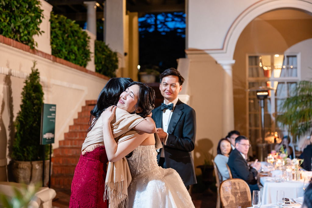 a heartfelt hug between bride and her best friend after wedding speech