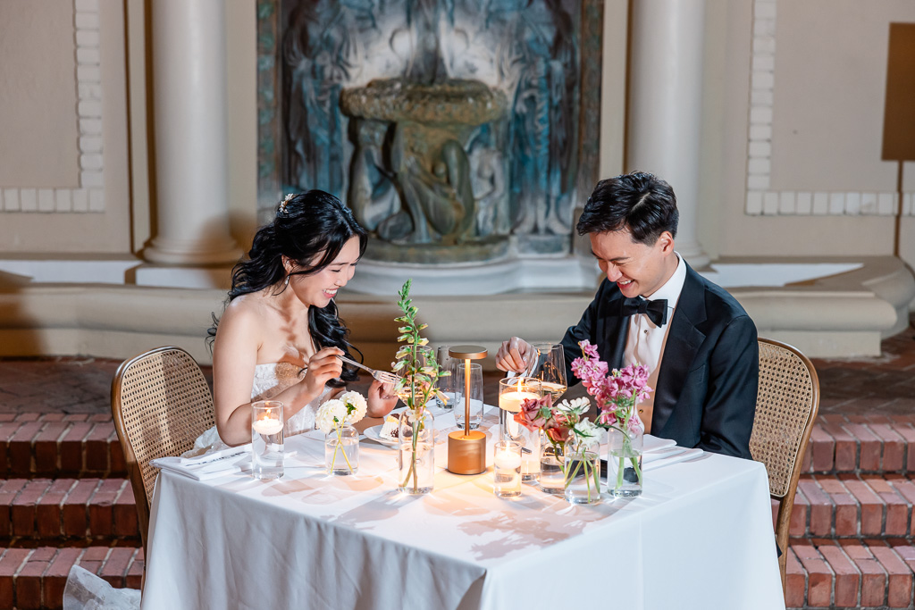 bride and groom happily eating their dinner