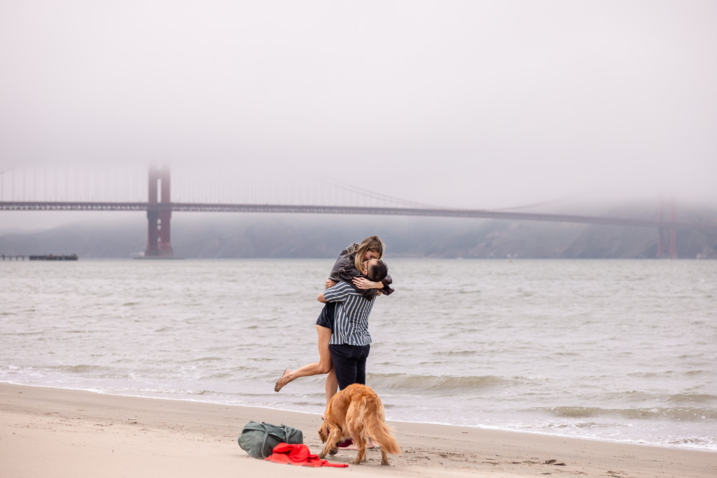 bride-to-be being lifted up into the air after proposal