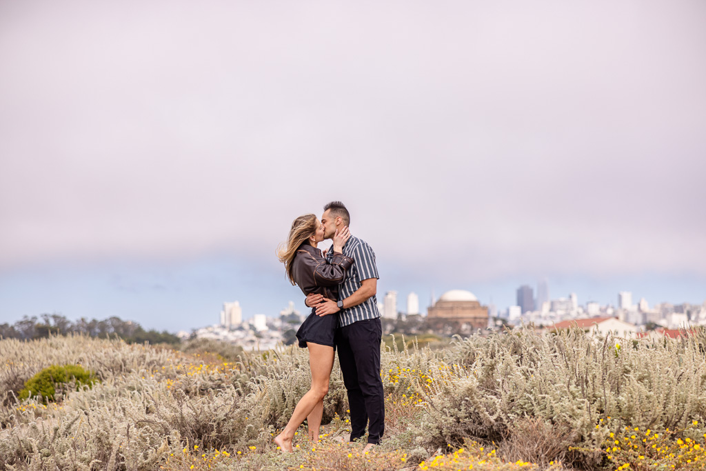 couple kissing with the Palace of Fine Arts and San Francisco city view in the background