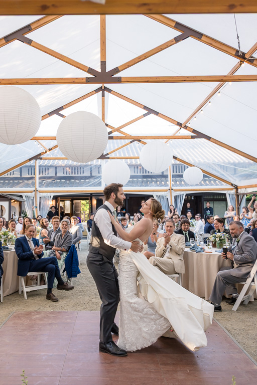 bride and groom dancing in front of their guests