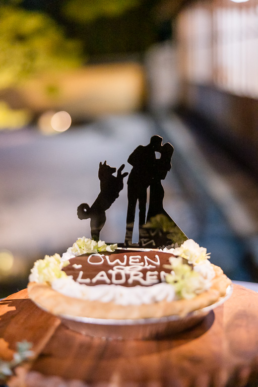cake topper with bride, groom, and dog