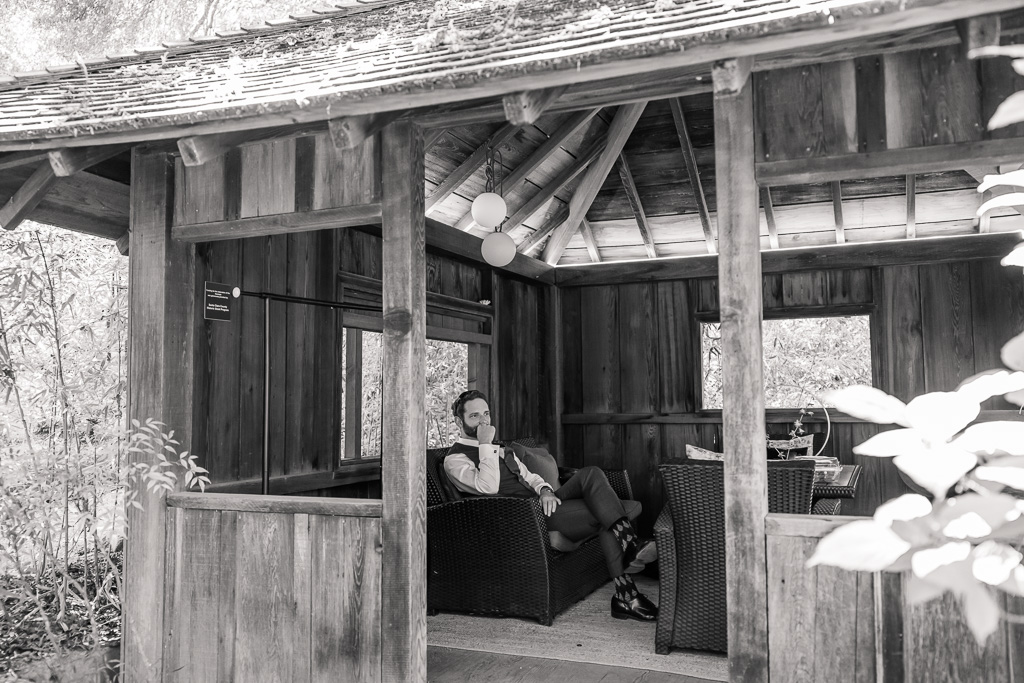 groom relaxing by himself in the gazebo