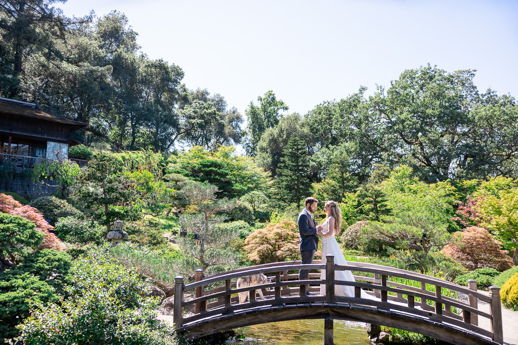 bride and groom giving each other private vows on the wooden bridge over the pond at Hakone Gardens