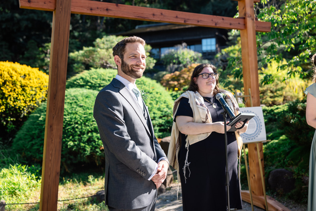 groom standing next to the officiant, waiting for the bride to enter