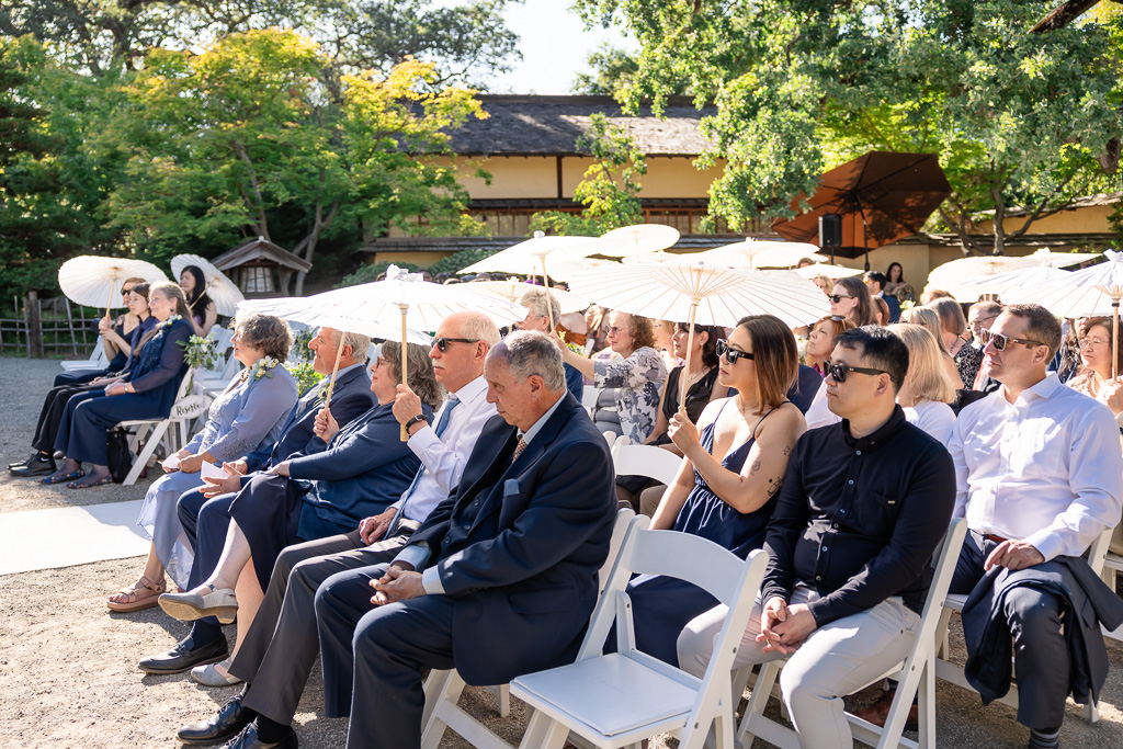 guests with white parasols