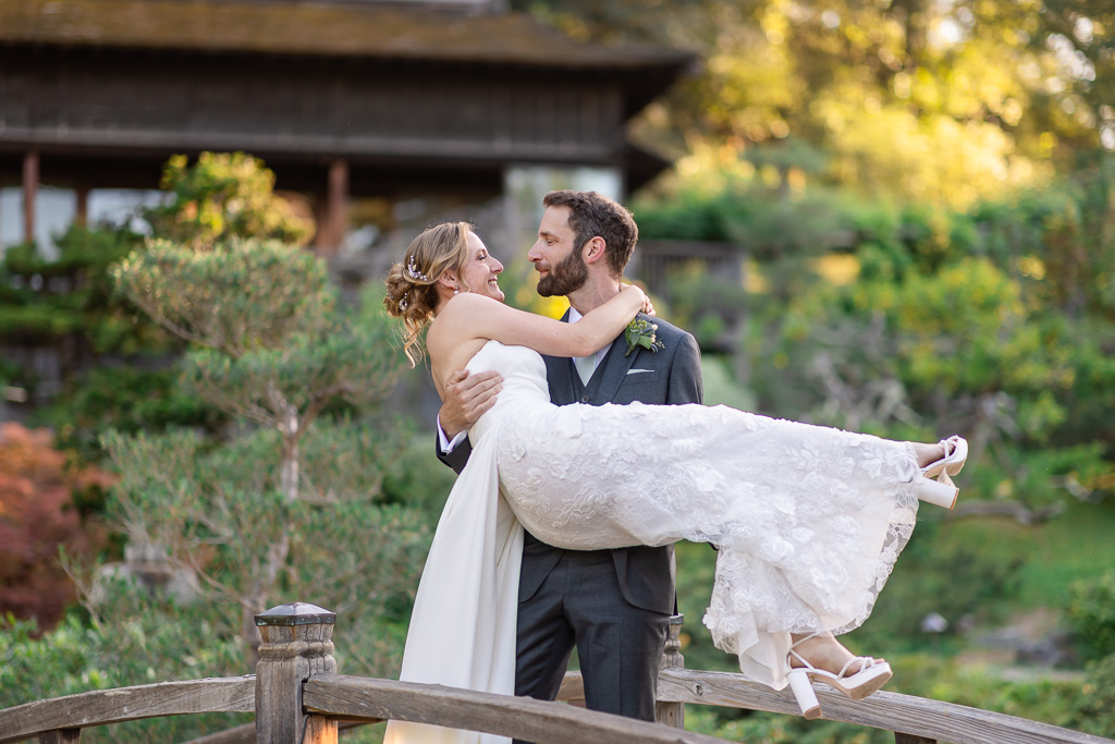 bride being picked up by the groom