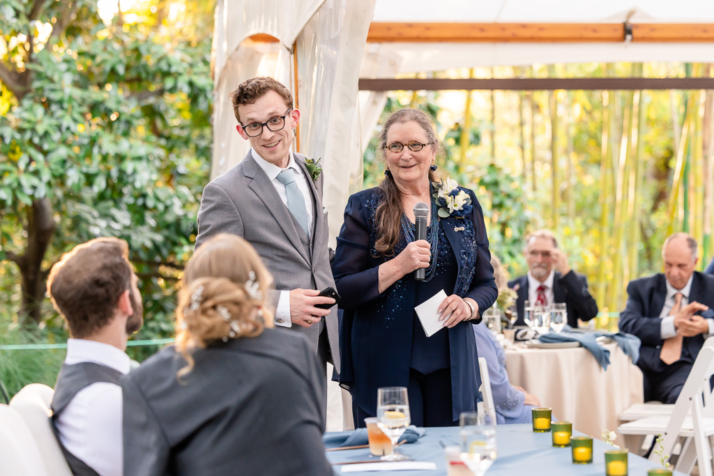 groom's mom and brother giving a toast