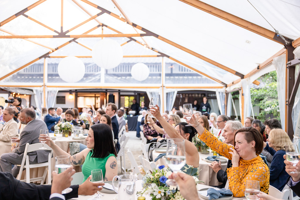 everybody raising a glass to the bride and groom