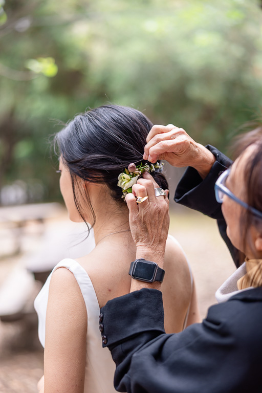 mom helping with bride's hair pin