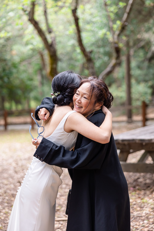 bride and mom hugging