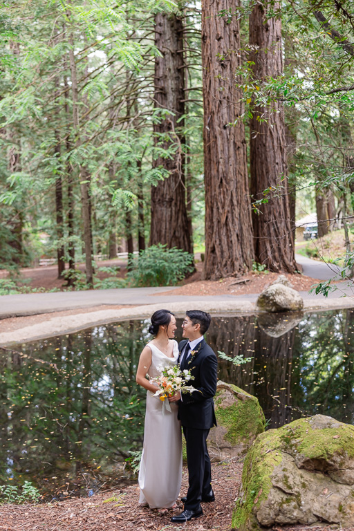 bride and groom wedding portrait at a lake in a forest