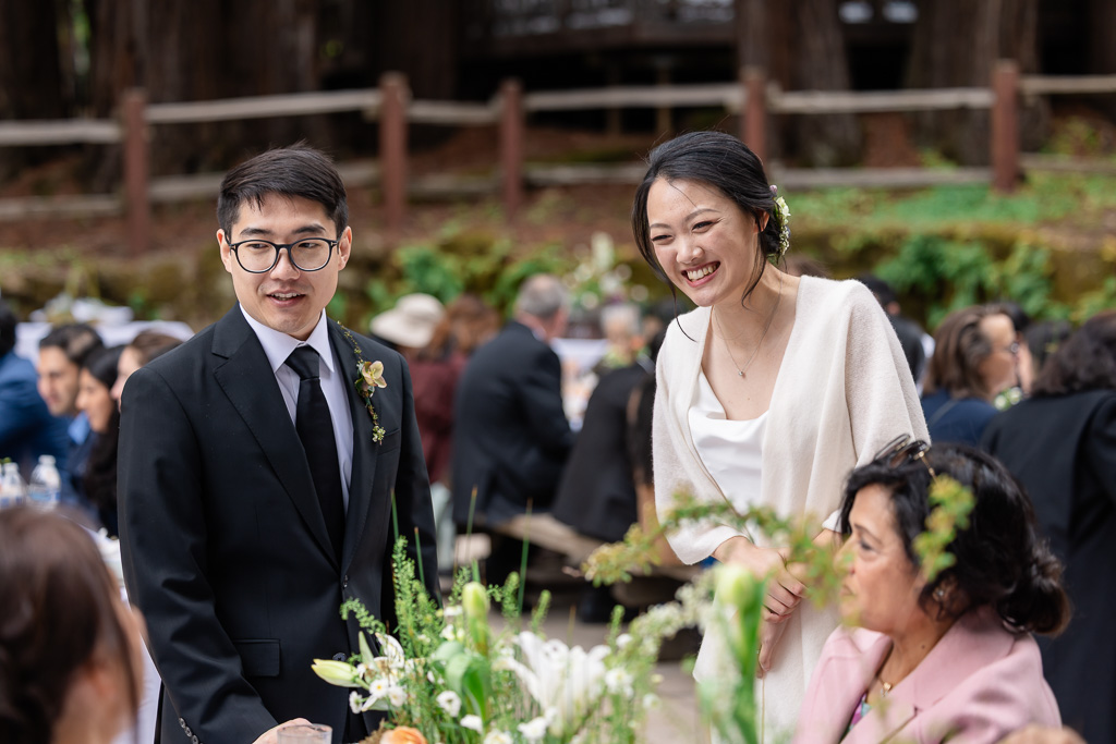 bride and groom visiting reception tables