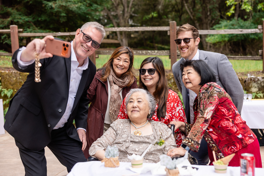 some guests taking a selfie with grandma