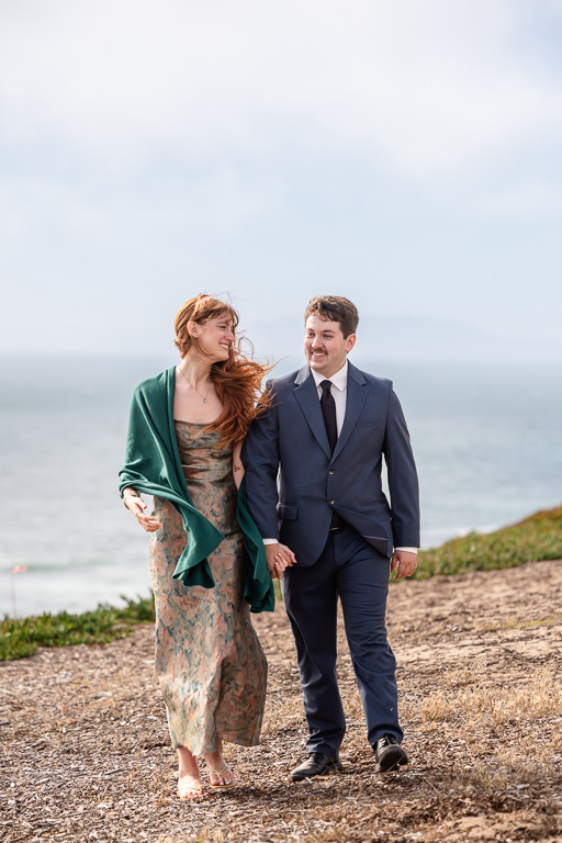 couple walking along the cliffs by the ocean