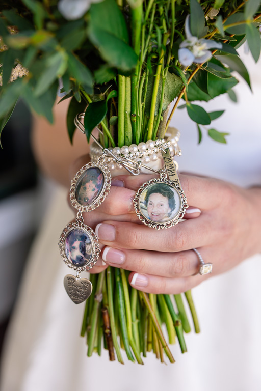 bride holding her wedding bouquet with photos of memoirs