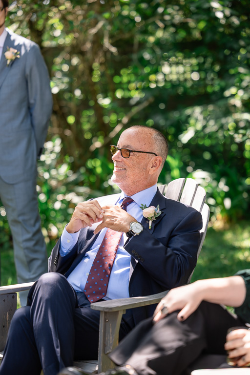 guest sitting on a wooden lawn chair