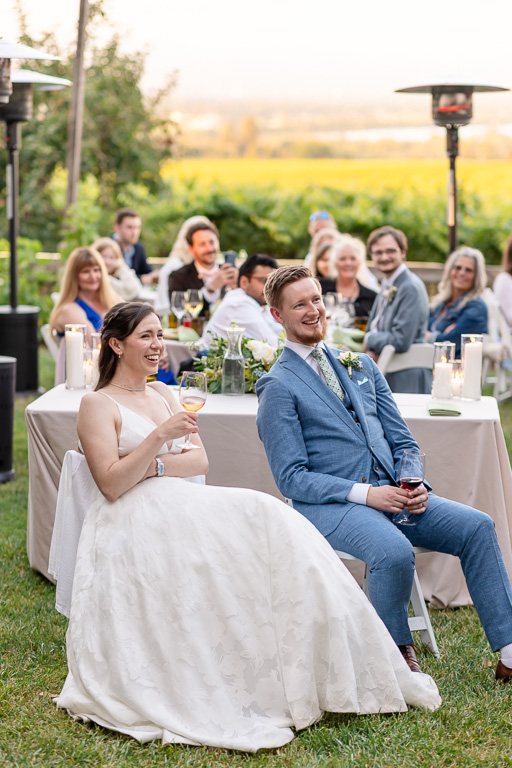bride and groom laughing at a dinner speech