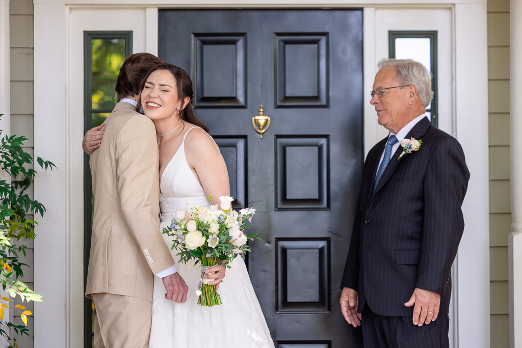 bride hugging her brother during their first look