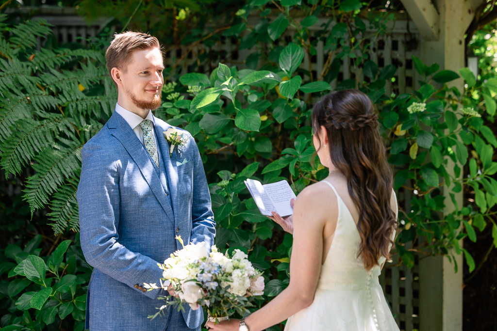 bride reading private vows to her groom after first look