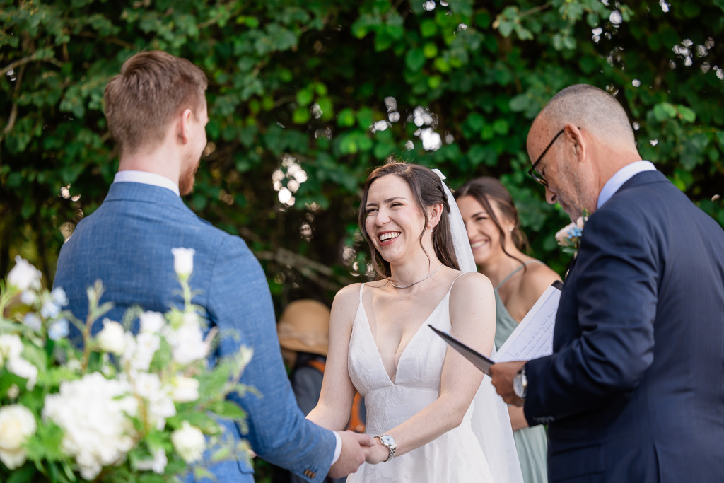 bride laughing during the wedding ceremony