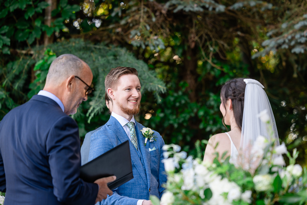 close-up of the groom looking at his bride during wedding ceremony