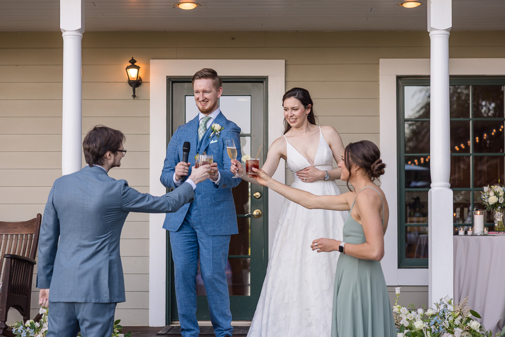 bride and groom toasting their best man and maid of honor