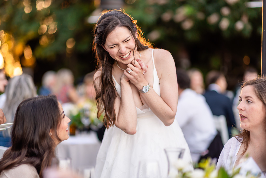 cute candid moment of the bride with her friends during the reception