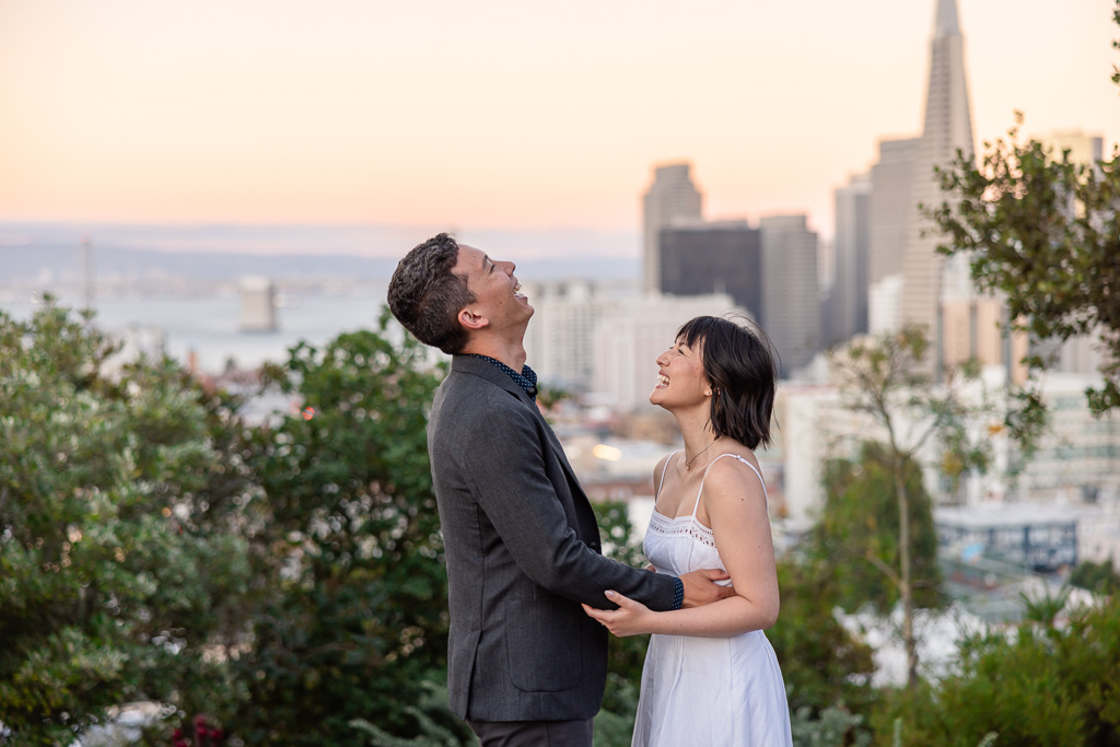 candid of couple laughing at each other right after they got engaged