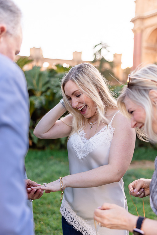 parents checking out daughter's new engagement ring after proposal