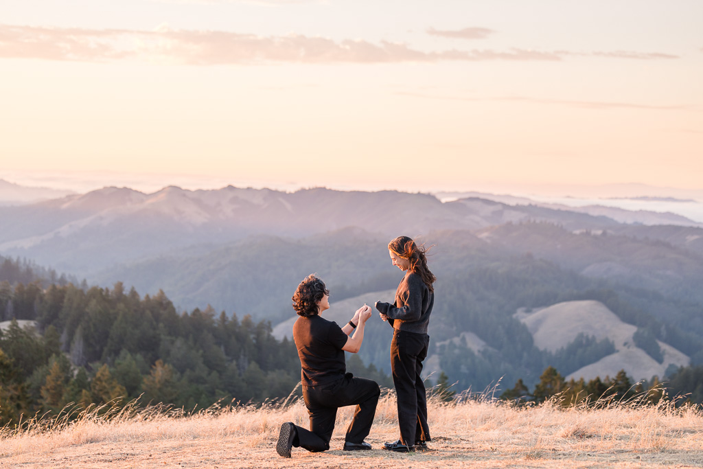 surprise proposal in the mountains at sunset