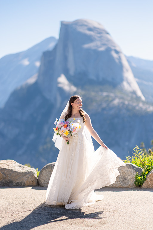natural candid shot of bride playing with her dress