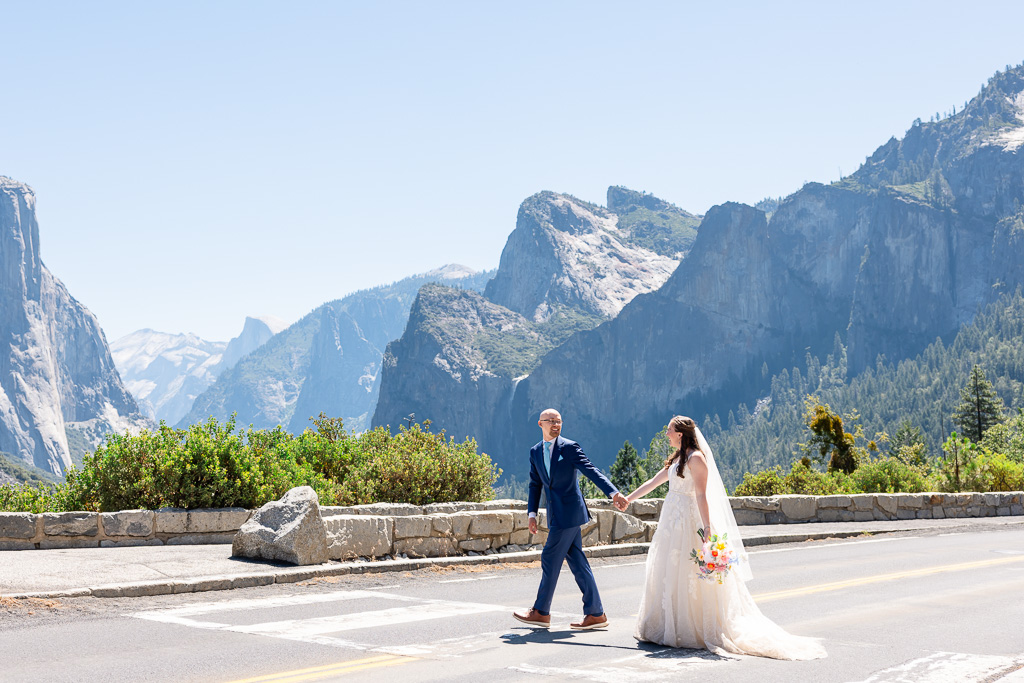 bride and groom crossing the street at Tunnel View in Yosemite