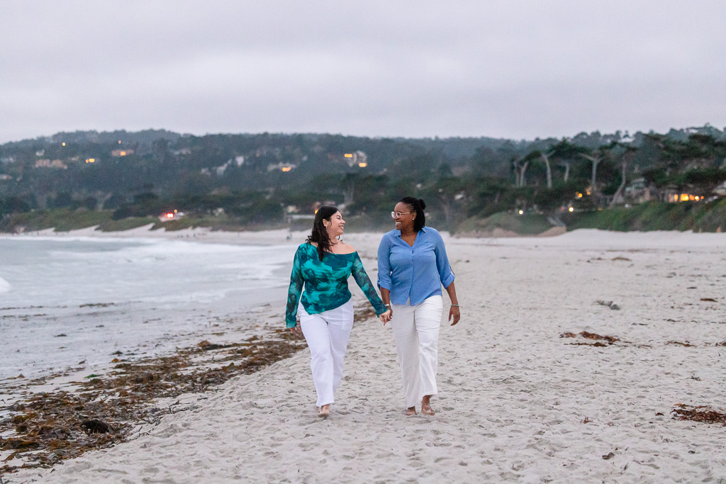 couple walking along Carmel Beach