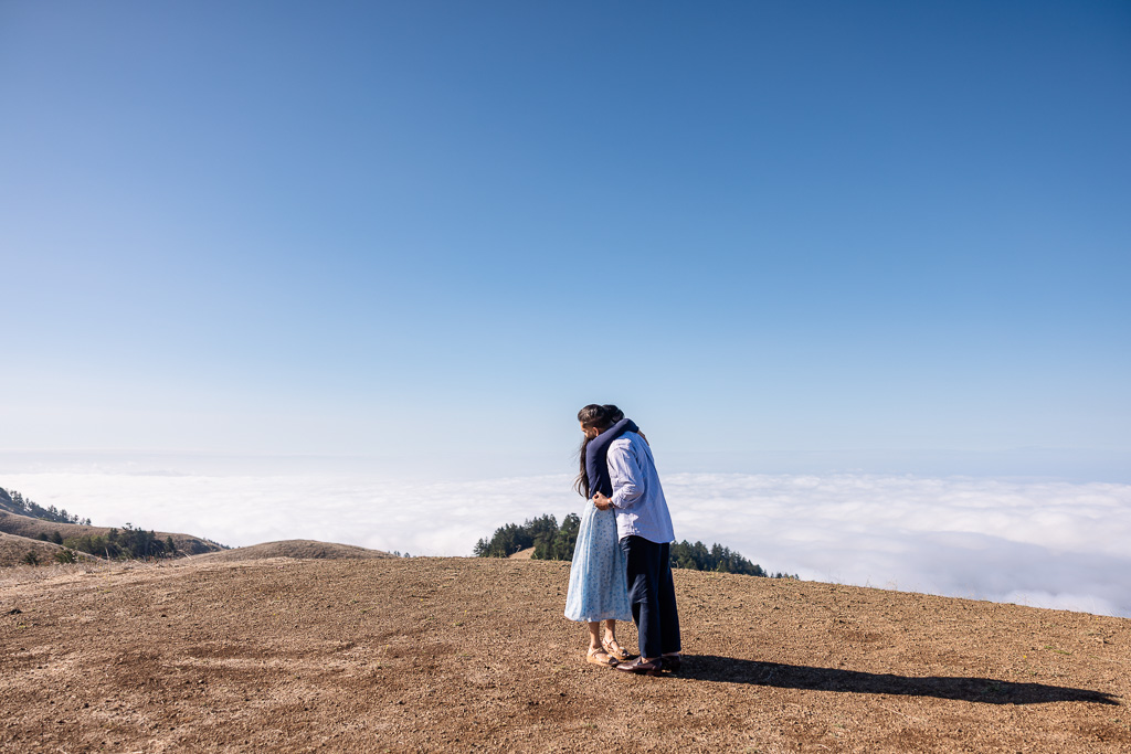 couple hugging at Mt Tam above clouds