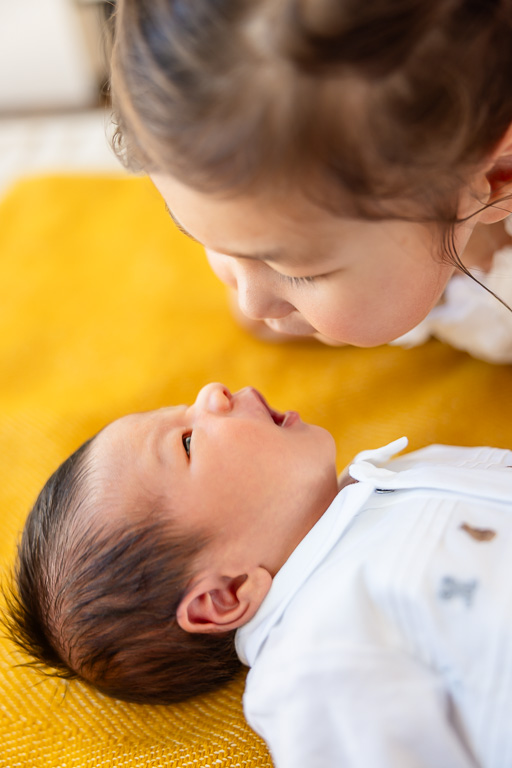 older sister and newborn baby