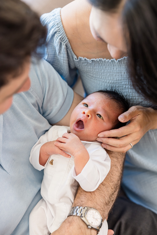 close-up of baby being held by both parents