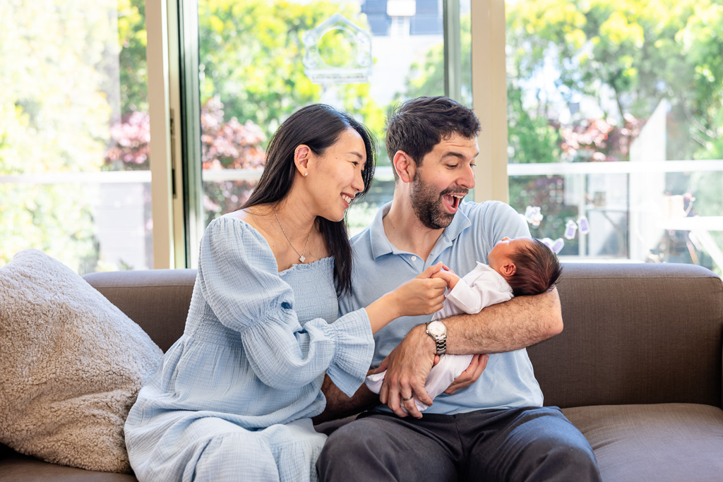 candid photo of parents with newborn baby