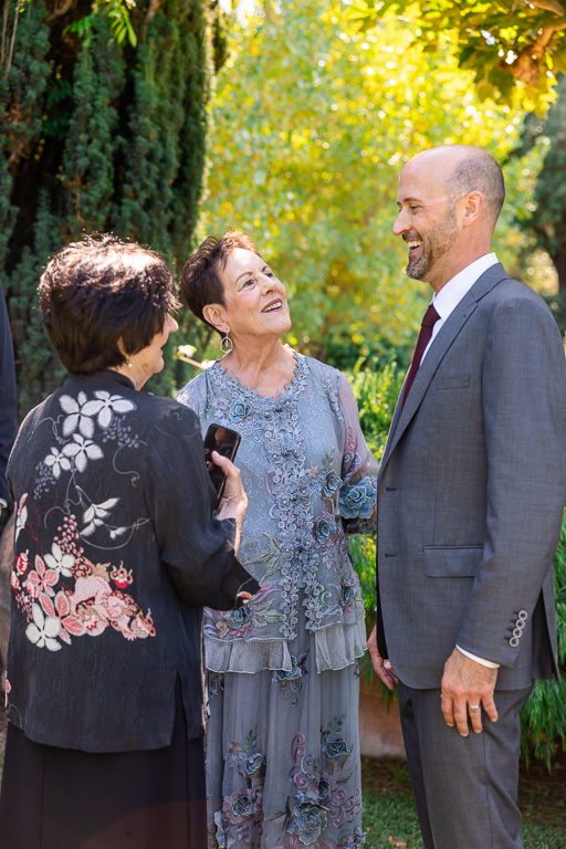 groom mingling with wedding guests during cocktail hour