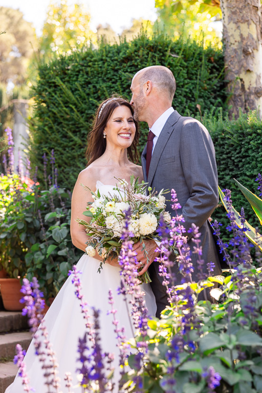 wedding portrait with purple flowers in a garden