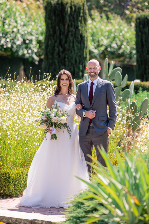 formal photo of the bride and groom in a garden