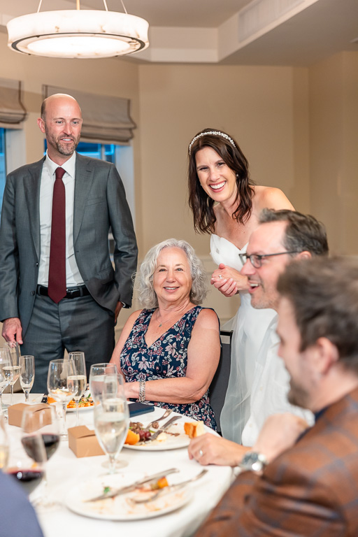 bride and groom visiting tables at their reception