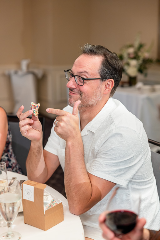 wedding guest pointing at dessert