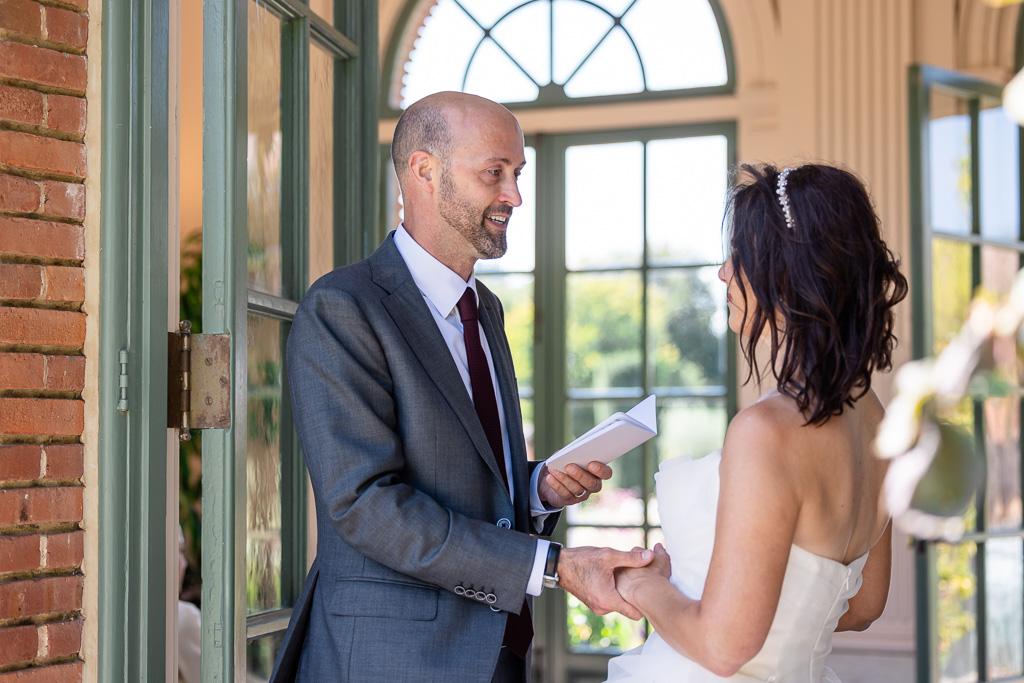 groom reading his private wedding vows to his bride