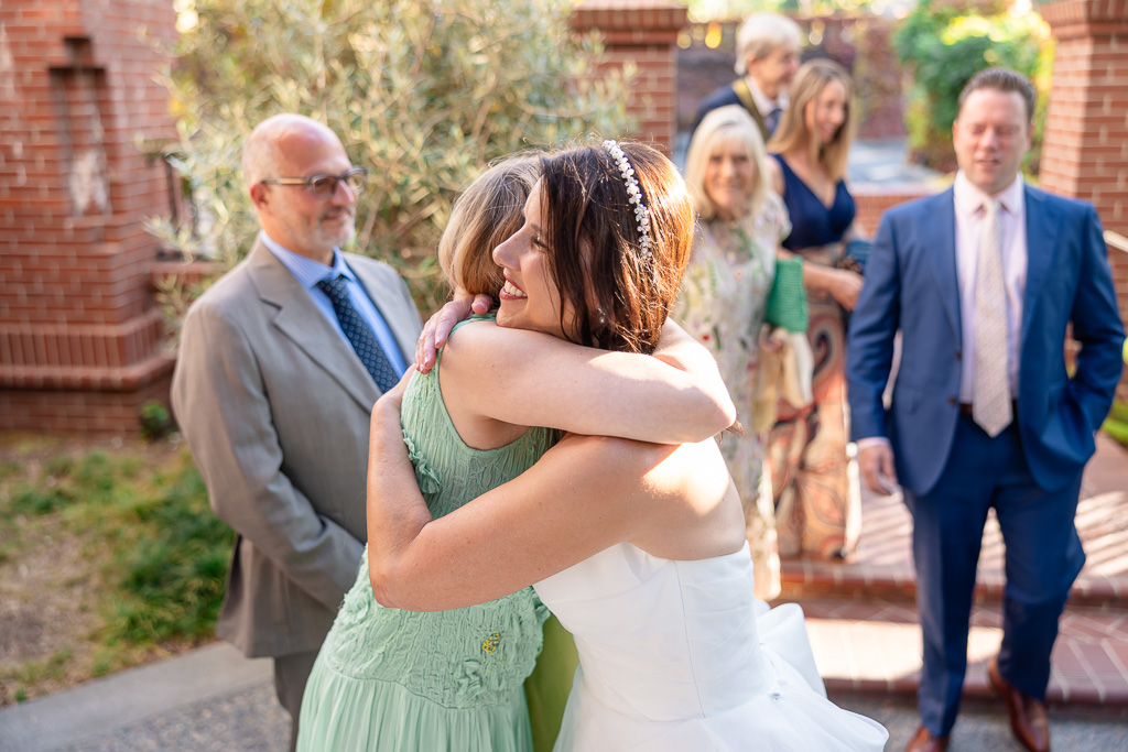 bride hugging a friend at the reception