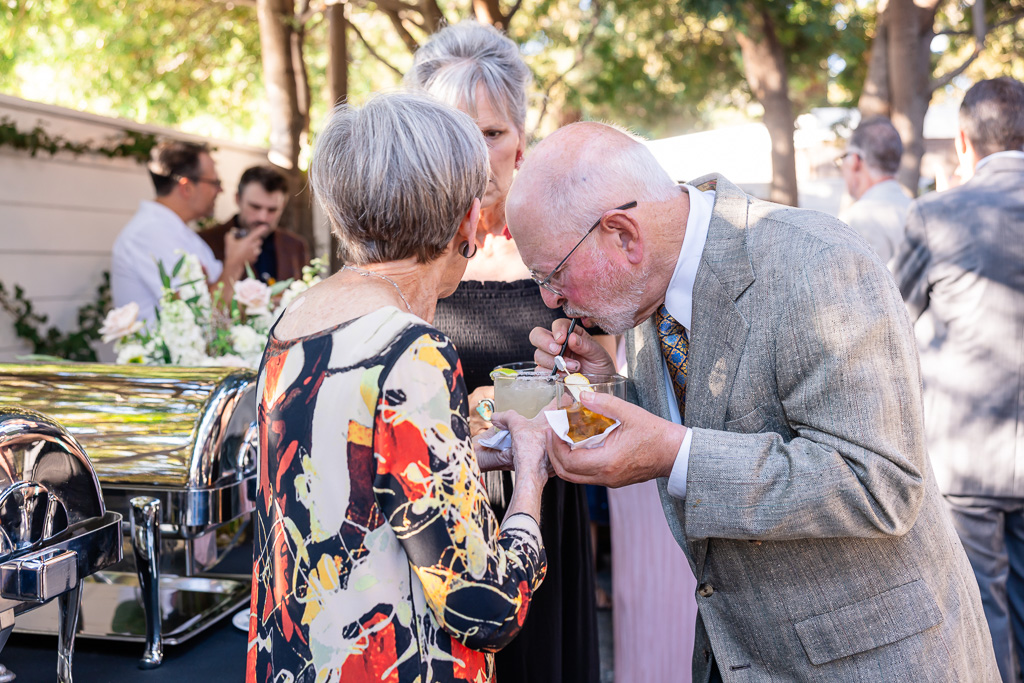 husband sneaking a sip of wife’s drink