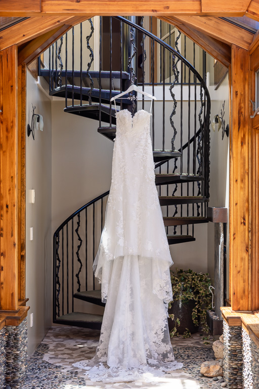 wedding dress hanging on a spiral staircase