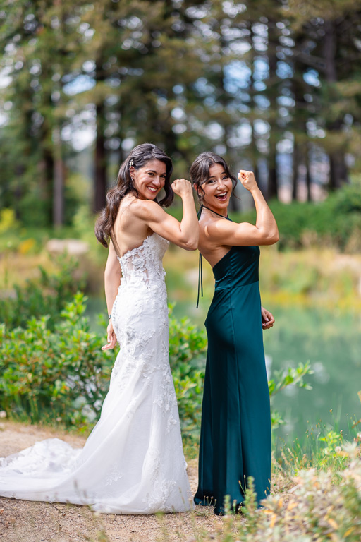 bride and her sister showing off impressive bicep muscles