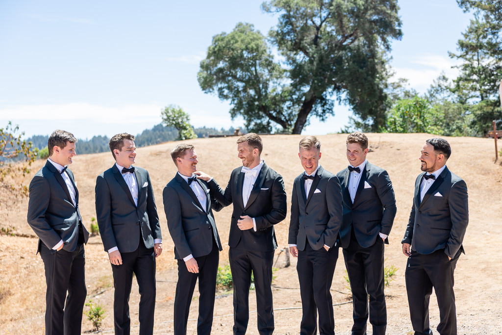 groom with his groomsmen outside on a sunny day