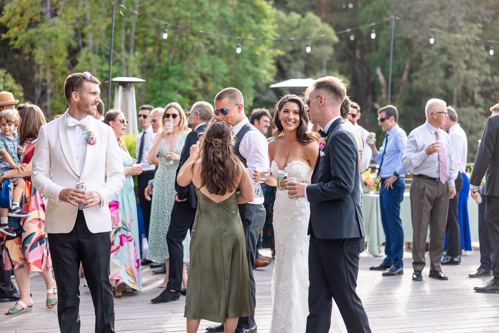 candid photo of bride and groom enjoying time with their guests